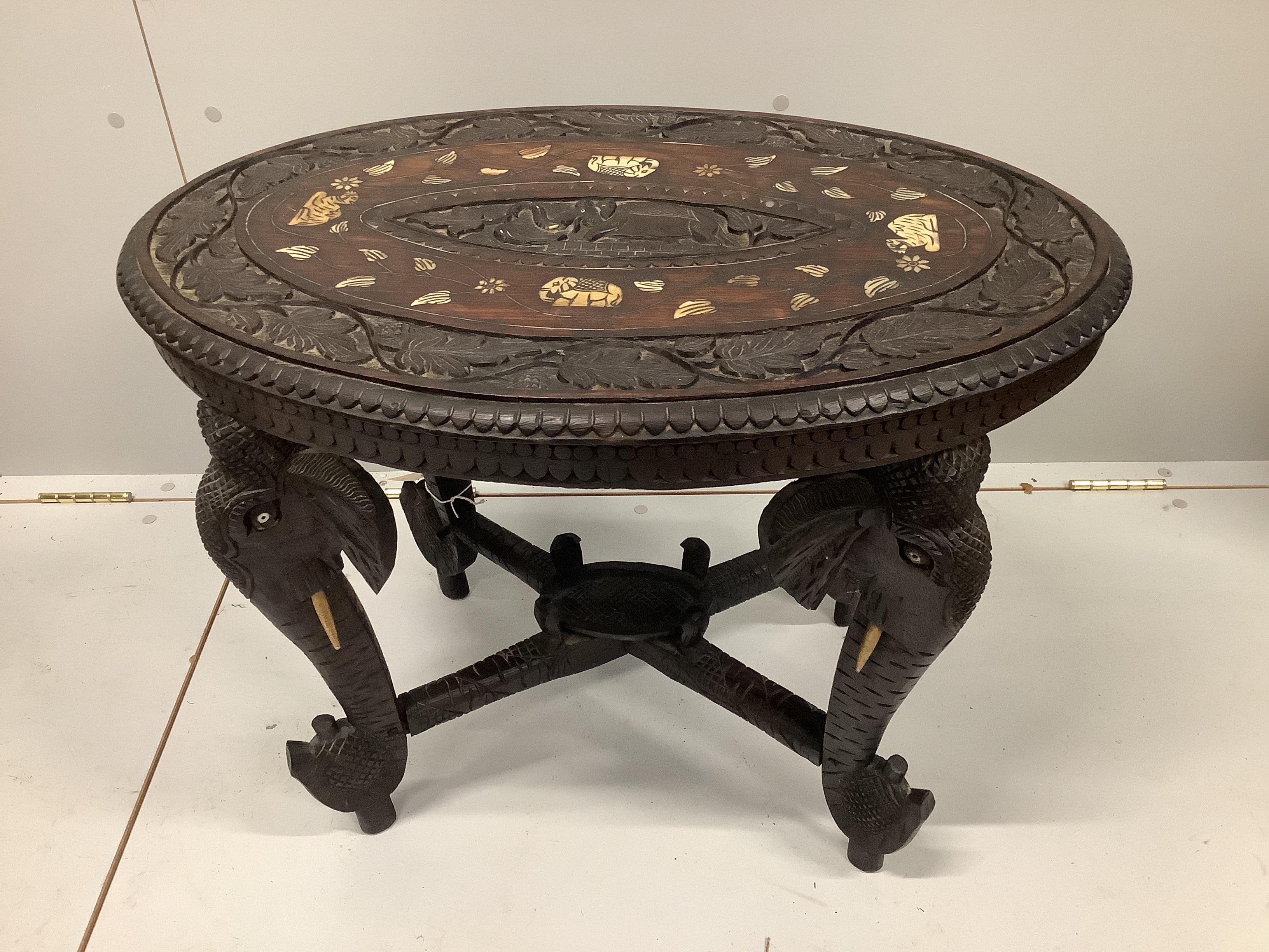 An oval Indian bone inlaid carved hardwood occasional table, width 68cm, depth 46cm, height 52cm